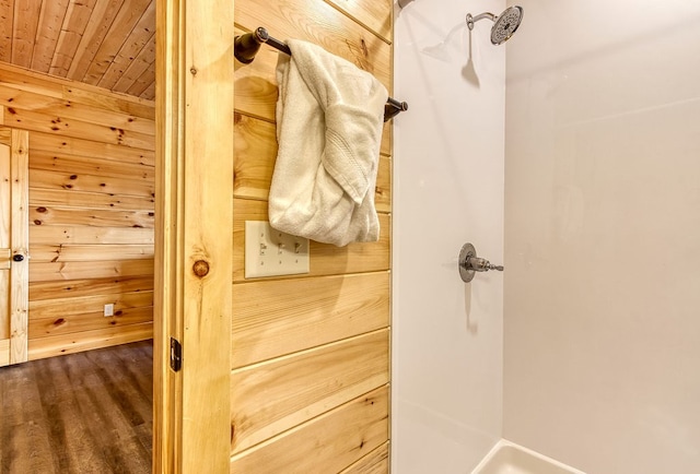 bathroom with wooden ceiling and wooden walls