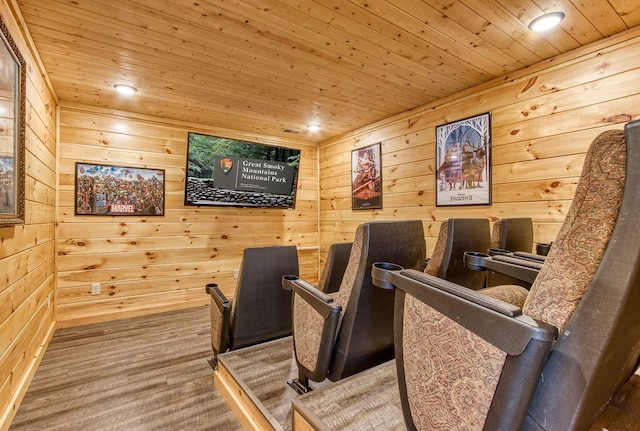 home theater room featuring wooden walls, wood ceiling, and hardwood / wood-style flooring