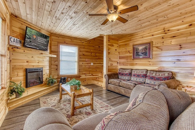 living room with log walls, hardwood / wood-style floors, ceiling fan, and wood ceiling