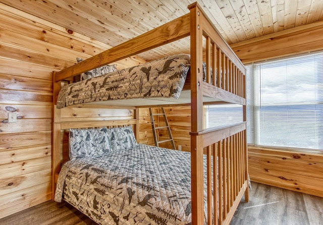 bedroom featuring hardwood / wood-style floors and wooden ceiling