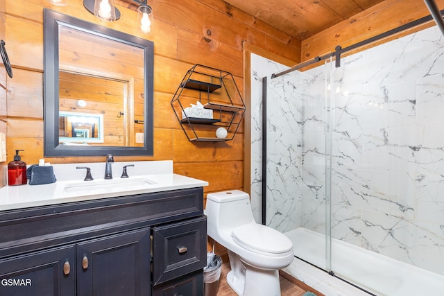 bathroom featuring toilet, vanity, wooden walls, and a shower with door