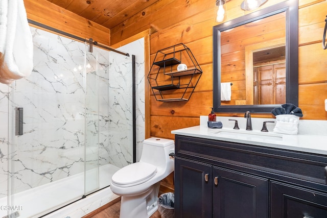 bathroom featuring vanity, a shower with shower door, toilet, and wood walls