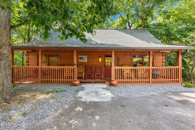 log cabin featuring a porch