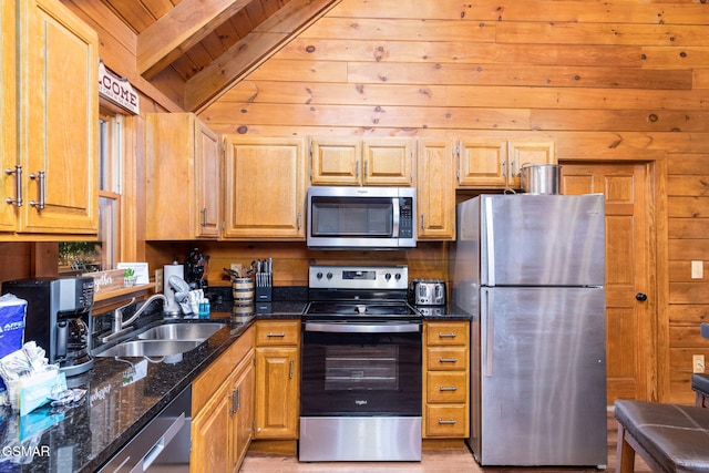 kitchen featuring sink, dark stone countertops, wooden walls, stainless steel appliances, and wooden ceiling