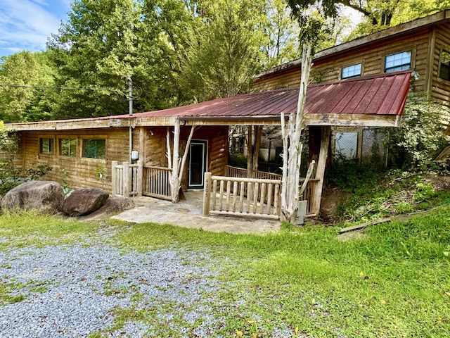 4205 Birds Creek Rd, Sevierville, TN 37876 - view of front of home featuring faux log siding and metal roof