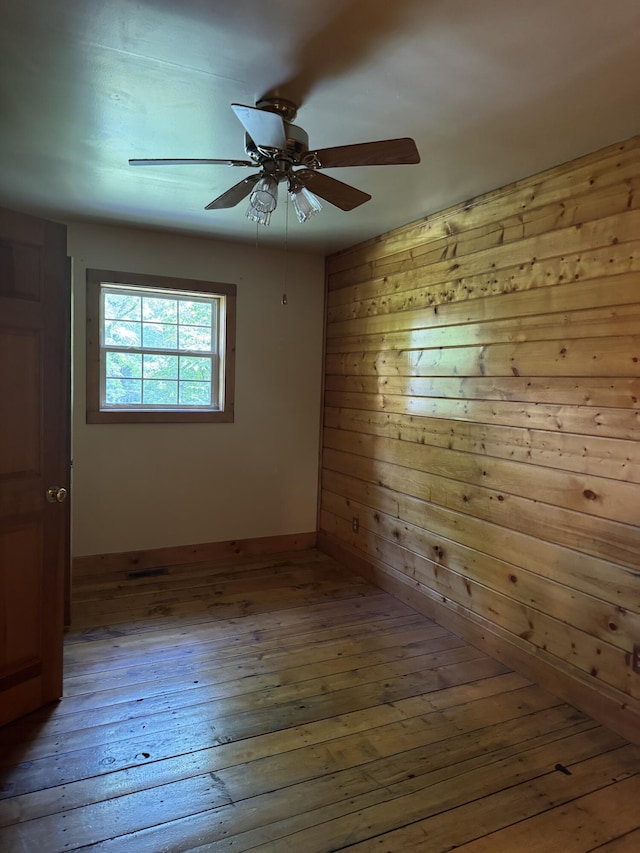 4205 Birds Creek Rd, Sevierville, TN 37876 - empty room with wooden walls, hardwood / wood-style floors, and a ceiling fan