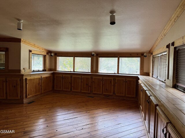 4205 Birds Creek Rd, Sevierville, TN 37876 - kitchen featuring light wood finished floors, visible vents, brown cabinetry, and vaulted ceiling