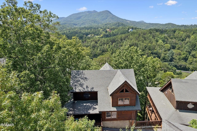 birds eye view of property with a mountain view and a view of trees