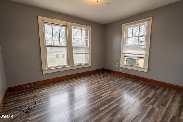 empty room featuring dark wood-type flooring and cooling unit