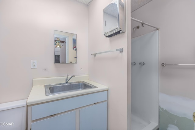 bathroom featuring vanity, toilet, and walk in shower