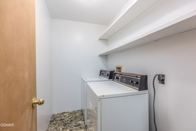 clothes washing area featuring washer and clothes dryer