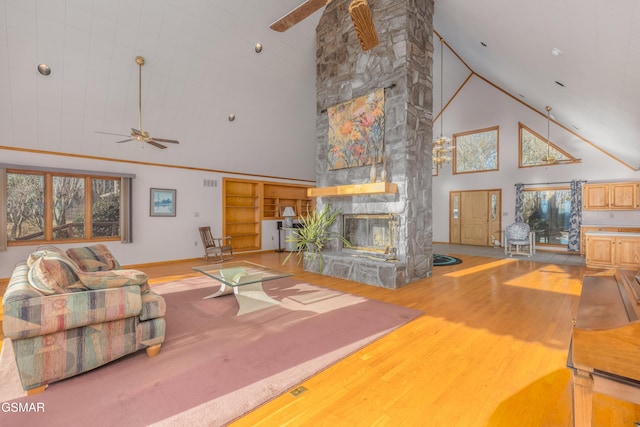 living room with high vaulted ceiling, a fireplace, light hardwood / wood-style floors, and ceiling fan