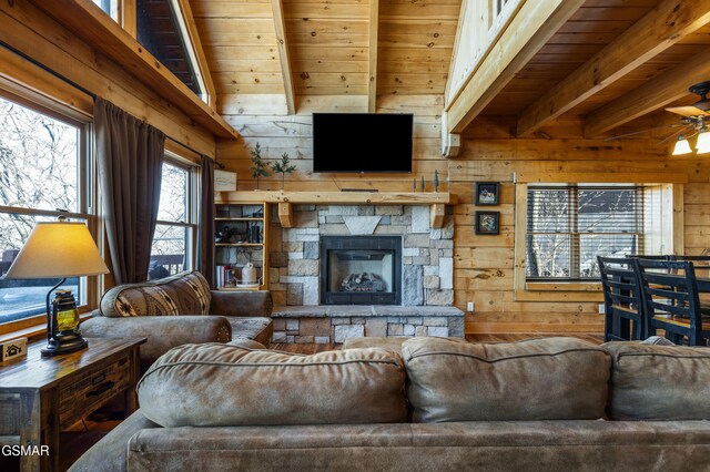 1274 Bear Cub Way, Gatlinburg, TN 37738 - living area with a stone fireplace, beamed ceiling, wood walls, and a ceiling fan