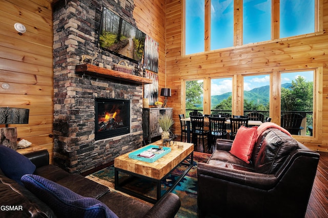 933 E Foothills Dr, Gatlinburg, TN 37738 - living room with wooden walls, a high ceiling, hardwood / wood-style floors, a fireplace, and a mountain view