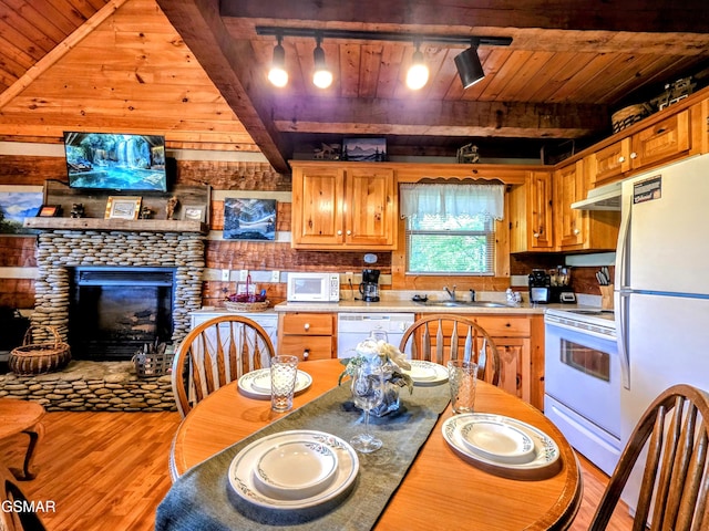 kitchen featuring wood ceiling, rail lighting, wood finished floors, a sink, and white appliances
