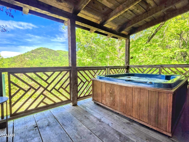 wooden deck featuring a hot tub