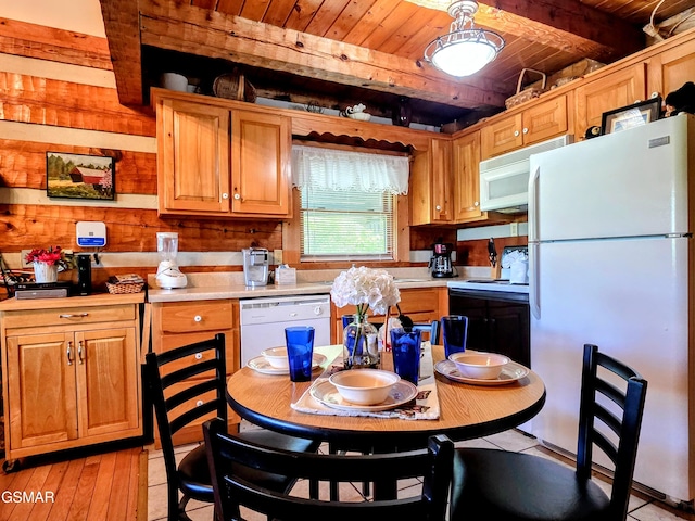 kitchen featuring wood walls, white appliances, beamed ceiling, light countertops, and wooden ceiling