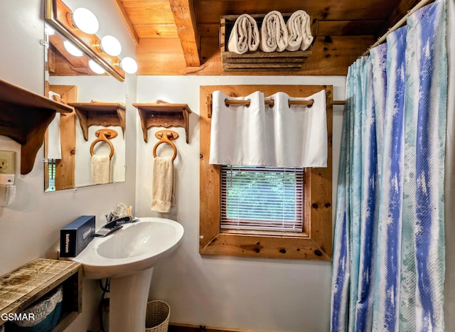 bathroom featuring a shower with shower curtain, wooden ceiling, and beam ceiling