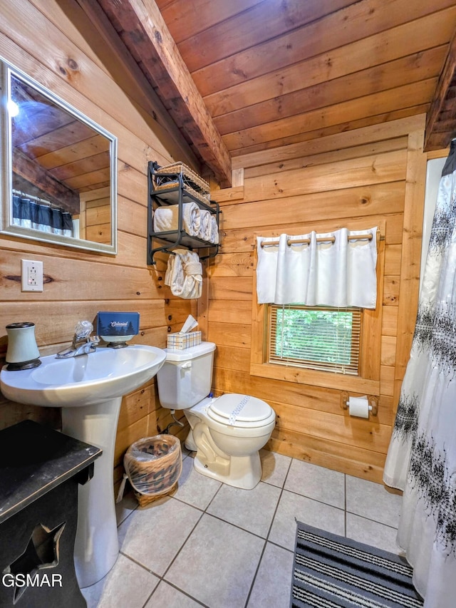 full bathroom with tile patterned flooring, wooden walls, wooden ceiling, and toilet