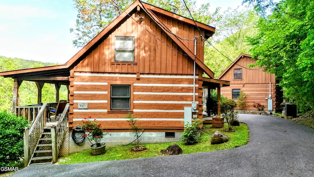 view of front facade featuring a wooden deck and board and batten siding