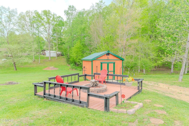 view of playground featuring a wooden deck, an outbuilding, a yard, and a storage shed