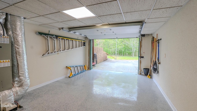 garage featuring baseboards and a textured wall