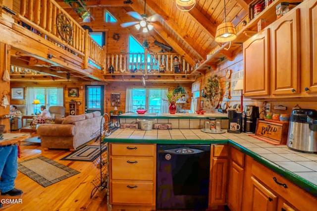 kitchen featuring tile counters, dishwasher, open floor plan, healthy amount of natural light, and wood ceiling