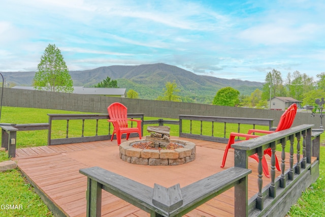 wooden terrace featuring a fire pit and a mountain view