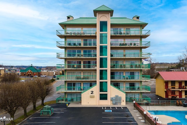 view of building exterior featuring uncovered parking