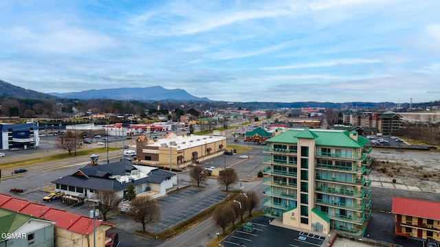 birds eye view of property with a view of city and a mountain view