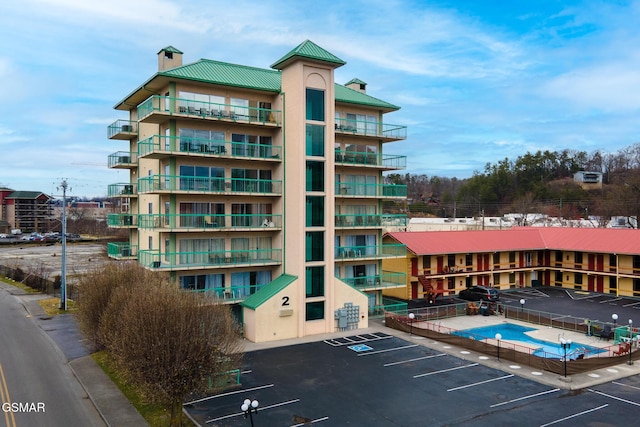 view of building exterior featuring uncovered parking