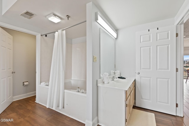 bathroom with shower / bath combination with curtain, visible vents, wood finished floors, and vanity