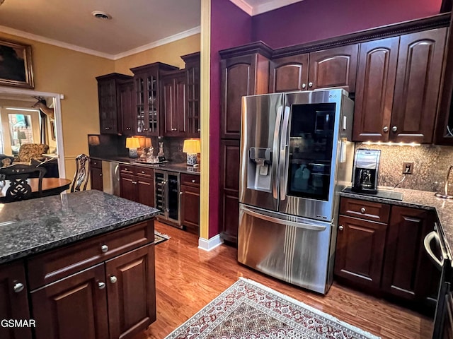 1042 Fine Glen Dr, Sevierville, TN 37862 - kitchen featuring stainless steel fridge, light wood-type flooring, wine cooler, decorative backsplash, and glass insert cabinets