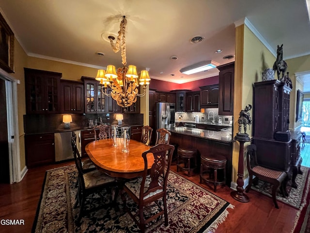 1042 Fine Glen Dr, Sevierville, TN 37862 - dining room with a chandelier, ornamental molding, and dark wood-style floors