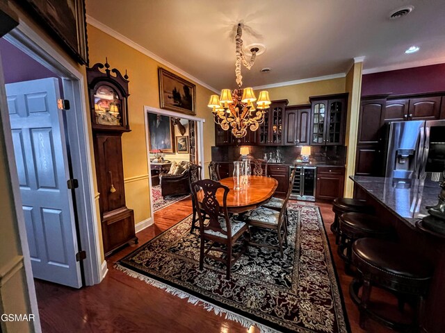 1042 Fine Glen Dr, Sevierville, TN 37862 - dining area with a chandelier, beverage cooler, ornamental molding, and dark wood-style floors