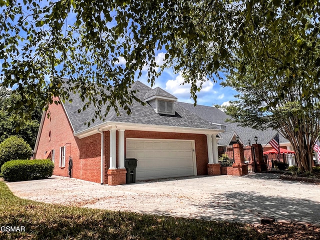 1042 Fine Glen Dr, Sevierville, TN 37862 - view of front of home featuring an attached garage, brick siding, roof with shingles, and driveway