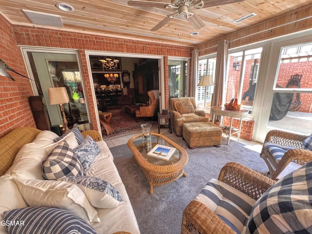 1042 Fine Glen Dr, Sevierville, TN 37862 - living area featuring wood ceiling, healthy amount of natural light, brick wall, a ceiling fan, and carpet flooring