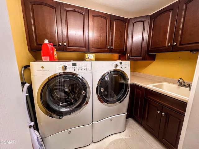 1042 Fine Glen Dr, Sevierville, TN 37862 - laundry area featuring cabinet space, washer and dryer, and light tile patterned floors