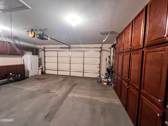 1042 Fine Glen Dr, Sevierville, TN 37862 - garage with freestanding refrigerator and a garage door opener