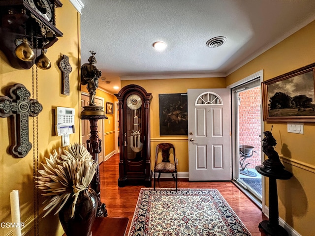1042 Fine Glen Dr, Sevierville, TN 37862 - foyer entrance featuring a textured ceiling, wood finished floors, and crown molding