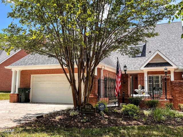 1042 Fine Glen Dr, Sevierville, TN 37862 - view of front facade with a shingled roof, brick siding, concrete driveway, and an attached garage
