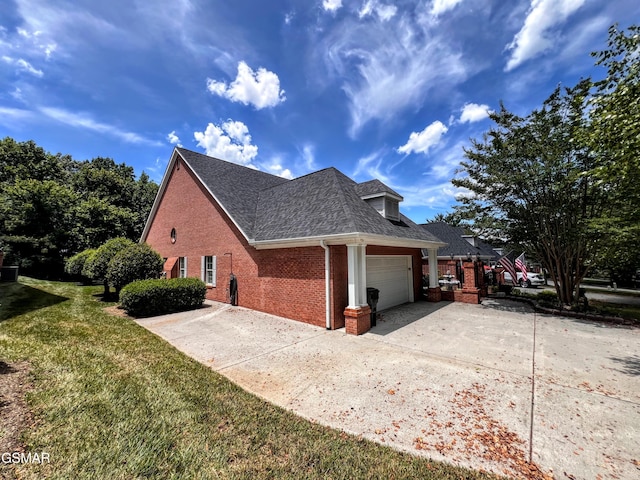 1042 Fine Glen Dr, Sevierville, TN 37862 - view of side of property with brick siding, a garage, roof with shingles, concrete driveway, and a lawn