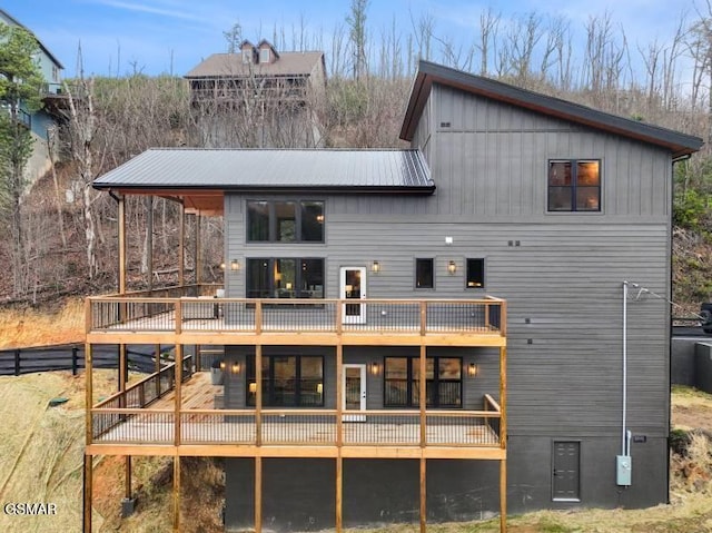 rear view of property featuring a deck