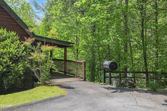 view of gate featuring a view of trees