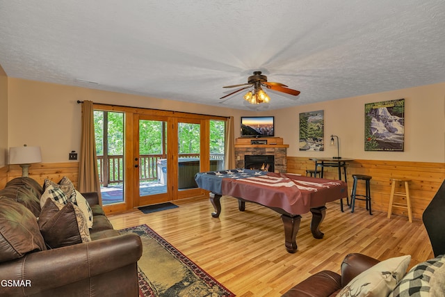 recreation room featuring a ceiling fan, a textured ceiling, billiards, and light wood-style flooring