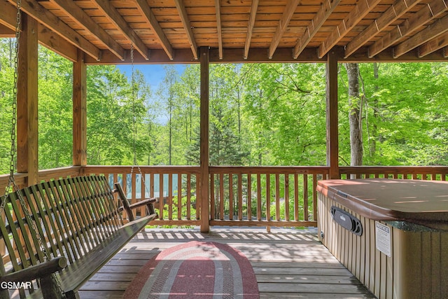 wooden terrace featuring a hot tub