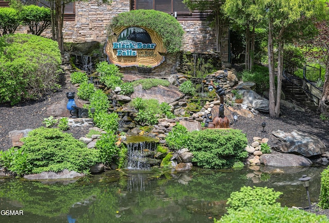 community sign featuring a small pond