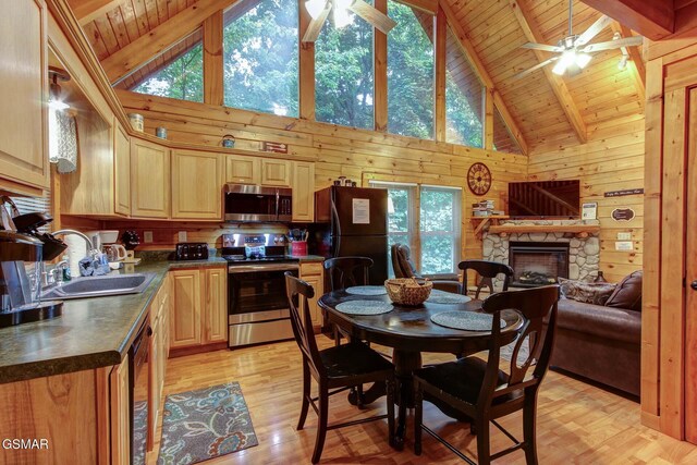 1925 Battle Top Rd, Sevierville, TN 37876 - dining area with ceiling fan, wood ceiling with exposed beams, plenty of natural light, wood walls, and high vaulted ceiling