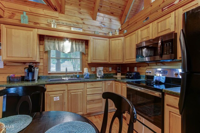 1925 Battle Top Rd, Sevierville, TN 37876 - kitchen with appliances with stainless steel finishes, a sink, wood walls, light brown cabinetry, and dark countertops