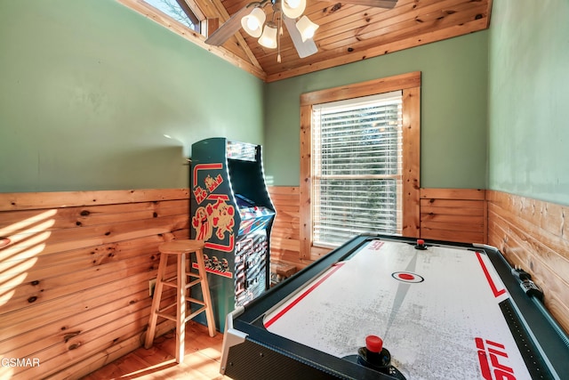 recreation room featuring wooden walls, wainscoting, ceiling fan, wood ceiling, and vaulted ceiling